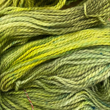 Load image into Gallery viewer, Green skein of yarn on a wooden surface
