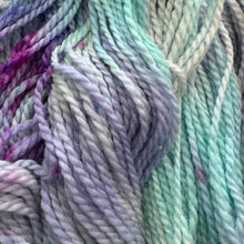 Load image into Gallery viewer, Close-up of multicolored yarn with shades of green, purple, and pink.
